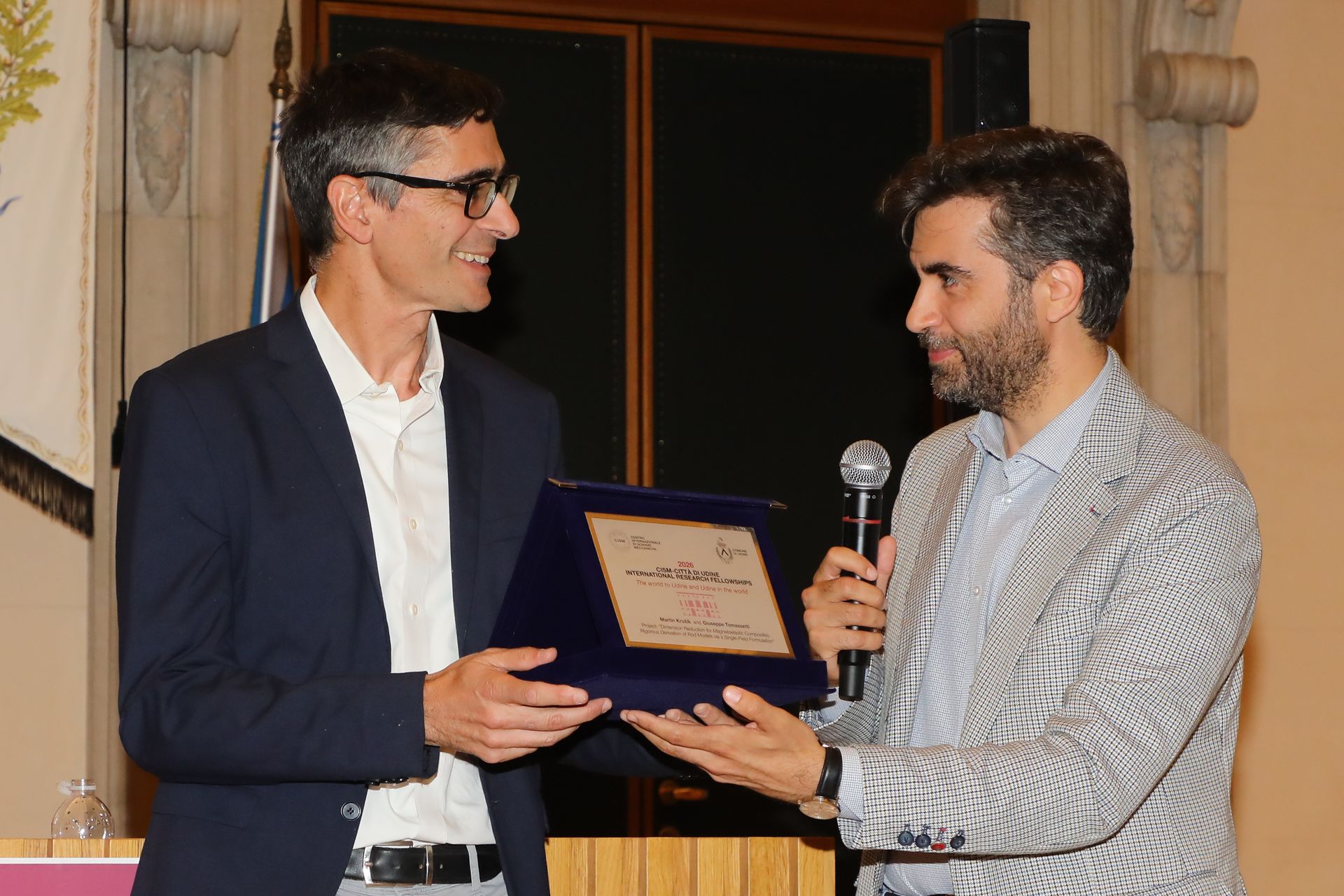 Federico Pirone, Councillor of Udine, stands with Giuseppe Tomassetti during the award presentation ceremony in Udine.